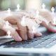 Closeup of business woman hand typing on laptop keyboard